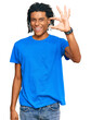 © Krakenimages.com - Young african american man wearing casual clothes smiling and confident gesturing with hand doing small size sign with fingers looking and the camera. measure concept.
