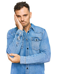 Poster - Young hispanic man wearing casual denim jacket thinking looking tired and bored with depression problems with crossed arms.