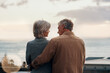 © ThaaJamSession/peopleimages.com - Back, morning or love and senior couple outdoor on balcony of home together with view of horizon or ocean. Holiday, sea and sky with elderly people in suburban neighborhood for bonding or vacation