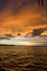 Wall Mural - sun setting over the gulf of mexico from the point of view of a viewer on a boat.