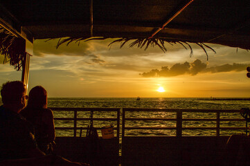 Wall Mural - sunset cruise views from the boat. other boats seen on the horizon as the sun is setting