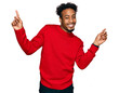 © Krakenimages.com - Young african american man with beard wearing casual winter sweater smiling confident pointing with fingers to different directions. copy space for advertisement