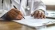 © Maxine - Close up of a doctor writing medical paperwork on a desk in their office, with copy space for text. Professional photography, high resolution, Doctor writing, medical paperwork, office, close up, hand