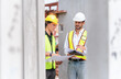 © Poguz.P - Engineer man in hardhat team working at construction site, Foreman worker inspect the construction site