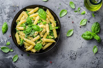 Canvas Print - Pasta and vegetables in creamy sauce in black bowl on grey stone background Top view Copy space