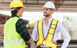 © Poguz.P - Engineer man in hardhat team working at construction site, Foreman worker inspect the construction site