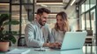 © yj - young business man and woman working together on laptop in the office, with copy space for text.