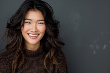 Poster - Portrait of beautiful smiling asian woman wearing brown sweater.