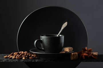 Wall Mural - Cup of black coffee with coffee beans, cinnamon, anise, and brown sugar.