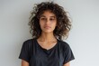 © LimeSky - Serious young Brazilian woman in casual t shirt poses naturally in front of camera on white background