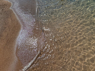 sea waves on the soft sandy shore of mediterranean coast.
