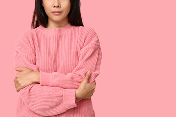 Poster - Young woman hugging herself on pink background, closeup