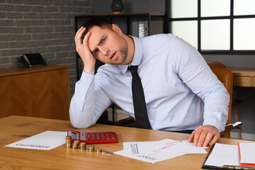 Wall Mural - Bankrupt businessman sitting at table in office