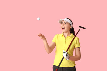 Wall Mural - Beautiful female golfer on pink background