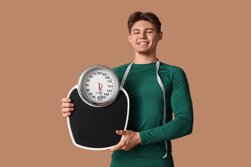 Poster - Sporty young man with scales and measuring tape on brown background. Weight loss concept