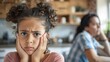 © Suphot - Upset child and parent having a disagreement in the kitchen, depicting family conflict and emotion.