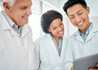 © Oostendorp/peopleimages.com - Group, scientist and tablet for medical research, teamwork and review in laboratory as employee or staff. People, doctors and technology with results, feedback or analysis for science or breakthrough