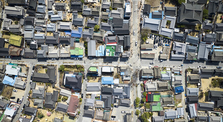 Wansan-gu, Jeonju-si, Jeollabuk-do, South Korea - March 18, 2023: Aerial and top angle view of tourists on the road and alley with tiled house at Jeonju Hanok village in spring
