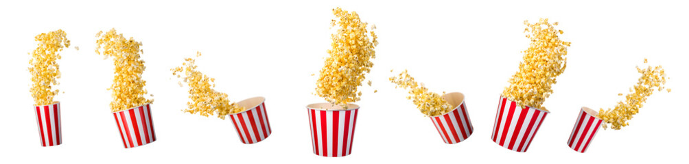 Canvas Print - Flying popcorn from paper striped bucket isolated on black background