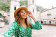 © maxbelchenko - Selfie while traveling. Young woman takes a selfie photo on a smartphone against the background of old city. Lifestyle, travel, tourism, weekend.