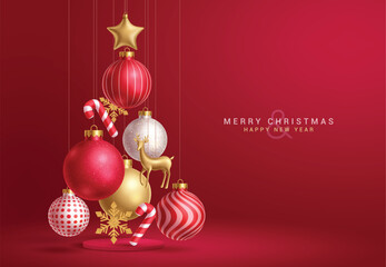 Wall Mural - Christmas balls red vector design. Merry christmas greeting text with hanging balls, bauble, gold deer, stars and snowflakes decoration ornaments in red elegant background. Vector illustration holiday