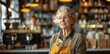 © olegganko - Senior Woman Working Behind Counter in a Coffee Shop