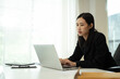 © Prathankarnpap - Focused businesswoman using laptop for online marketing research at her office