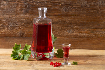 Wall Mural - Delicious homemade currant liqueur. Served in a glass and carafe. Served with currant cake.