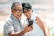 © peopleimages.com - Phone, travel and mature couple with app reading online tips for adventure, sightseeing or activity. Happy, bonding and senior people with cellphone for tourism navigation on holiday in Mexico.