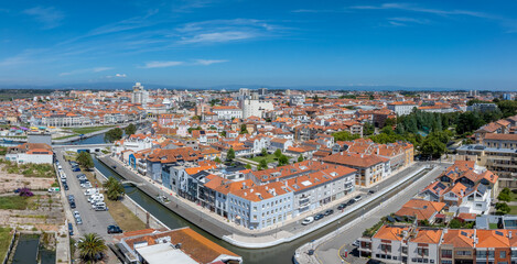 Wall Mural - Beautiful aerial view of Aveiro city in Portugal. Aveiro Water canal of Ria de Aveiro with typical boats and tourists, cityscape in the background.