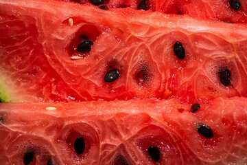 red and juicy pulp of ripe watermelon close-up, red fresh pulp of ripe watermelon with black seeds inside. Beautiful simple AI generated image in 4K, unique.