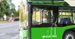 © Barillo Images - Young adult female person drives a green electric bus in city.