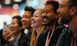 © cosmosgod - Close-Up of Happy and Laughing Group of Employees or Participants Listening to Startup Owner Speak at Trade Show Event. AI-Generated, High-Quality 4K Wallpaper.
