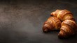 © EUT - Croissants arranged on dark surface. This photo is perfect for food blogs or websites featuring bakery goods.