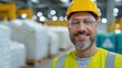 © sawitreelyaon - Close-up joyful business owner’s face , recycling facility machinery in the background.