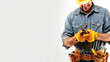 © Denis Yevtekhov - a construction worker with a tool belt, smiling while holding a completed piece of work, showcasing pride and accomplishment, Labor Day, worker, tools, with copy space