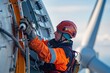 © mariodelavega - A close-up shot of a technician performing routine maintenance on the blade of an offshore wind turbine.
