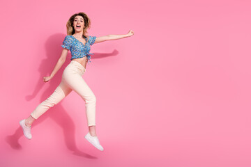 Sticker - Full body photo of attractive young woman flying superman excited dressed blue flower print clothes isolated on pink color background