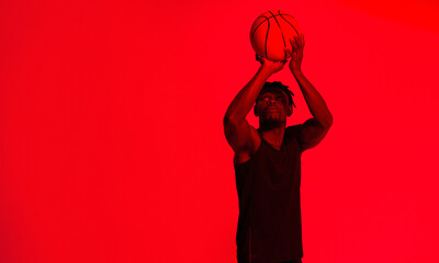 Canvas Print - Basketball, shooting and space with man in red filter lighting for challenge, game or performance. Aim, exercise and sports with African person on mockup in studio for competition or recreation