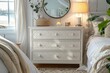© JIALU - White chest of drawers with geometric patterns, iron bed, bedside tables with lamps, Scandinavian interior design, soft pastel colors, large mirror, and home decor accessories.