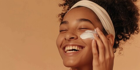 The picture shows a joyful woman applying skincare cream, emphasizing beauty and a skincare regimen to maintain youthful skin. She looks happy and healthy, radiating wellness and contentment