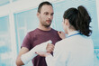 © Giulio_Fornasar - Doctor examining male patient with broken arm in hospital room
