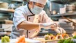 © Shaheen - A chef wearing a mask and gloves while preparing sushi, highlighting the importance of food safety in raw food handling. High-definition, hygiene, raw food preparation, kitchen safety, sushi making
