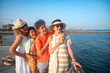 © C&A - Three-generation family on vacation in the Mediterranean, laughing together on a pier