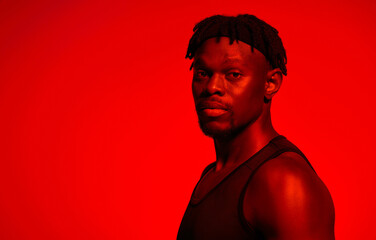 Poster - Black man, confident and red neon with studio background for sports, fitness and training. Male person, portrait and athlete for exercise or workout for self care, wellness and wellbeing with muscles