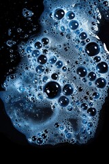 Poster - A close up shot of bubbles forming and popping in water on a black background, useful for science or beauty related images