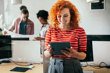 Sticker - Diverse group of happy employees analyzing reports together with papers, working together in office