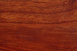 © Russell - Sapele wood grain features a vibrant, reddish-brown hue with a unique, interlocking texture that creates a striking visual effect, often used for fine furniture and cabinetry due to its durability