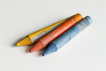 Wall Mural - A photo of three crayons placed side by side on a clean white surface