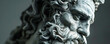 © Volodymyr - Close-up of a monochrome sculpture of Zeus, the Greek god, with intricate details capturing his stern expression and flowing beard.